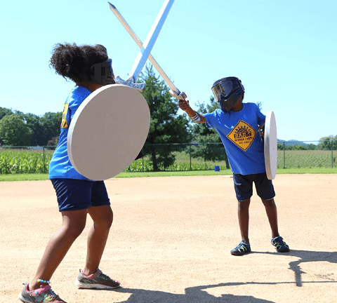 Two campers with LARP gear, role playing a sword fight