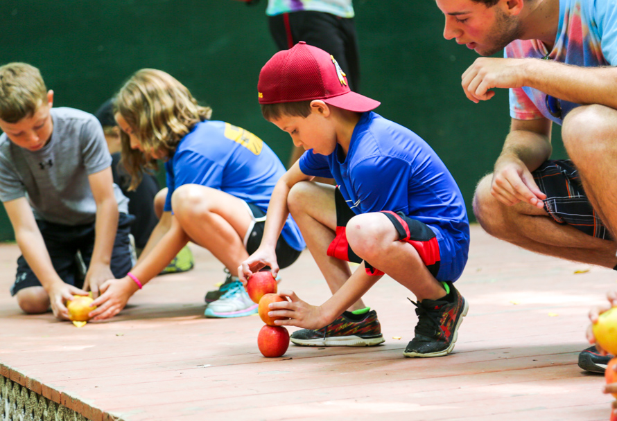 Campers stacking apples for the camp olympics