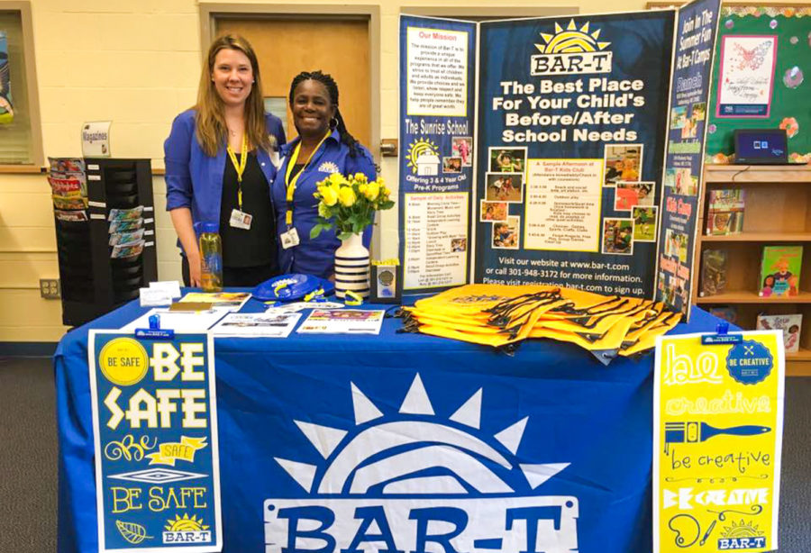 Two people behind the Be Safe Bar-T Booth