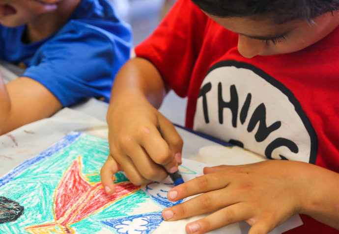 Camper coloring in a drawing with crayons