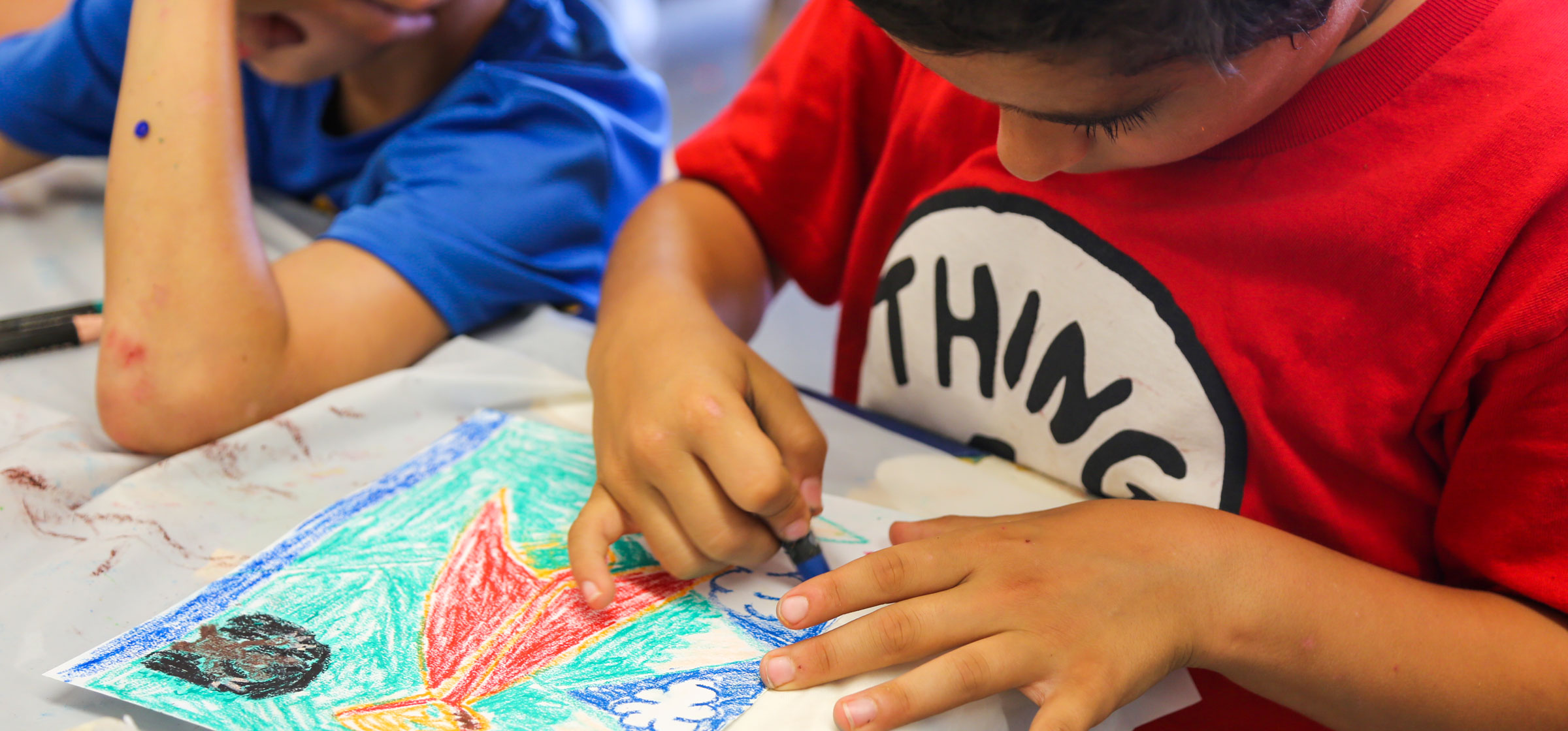 Camper coloring in a drawing with crayons