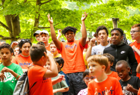 Campers outside in a group clapping