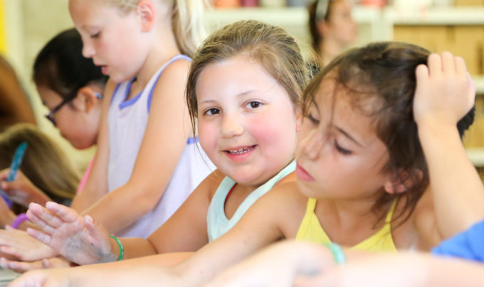 Campers at a table doing a school activity