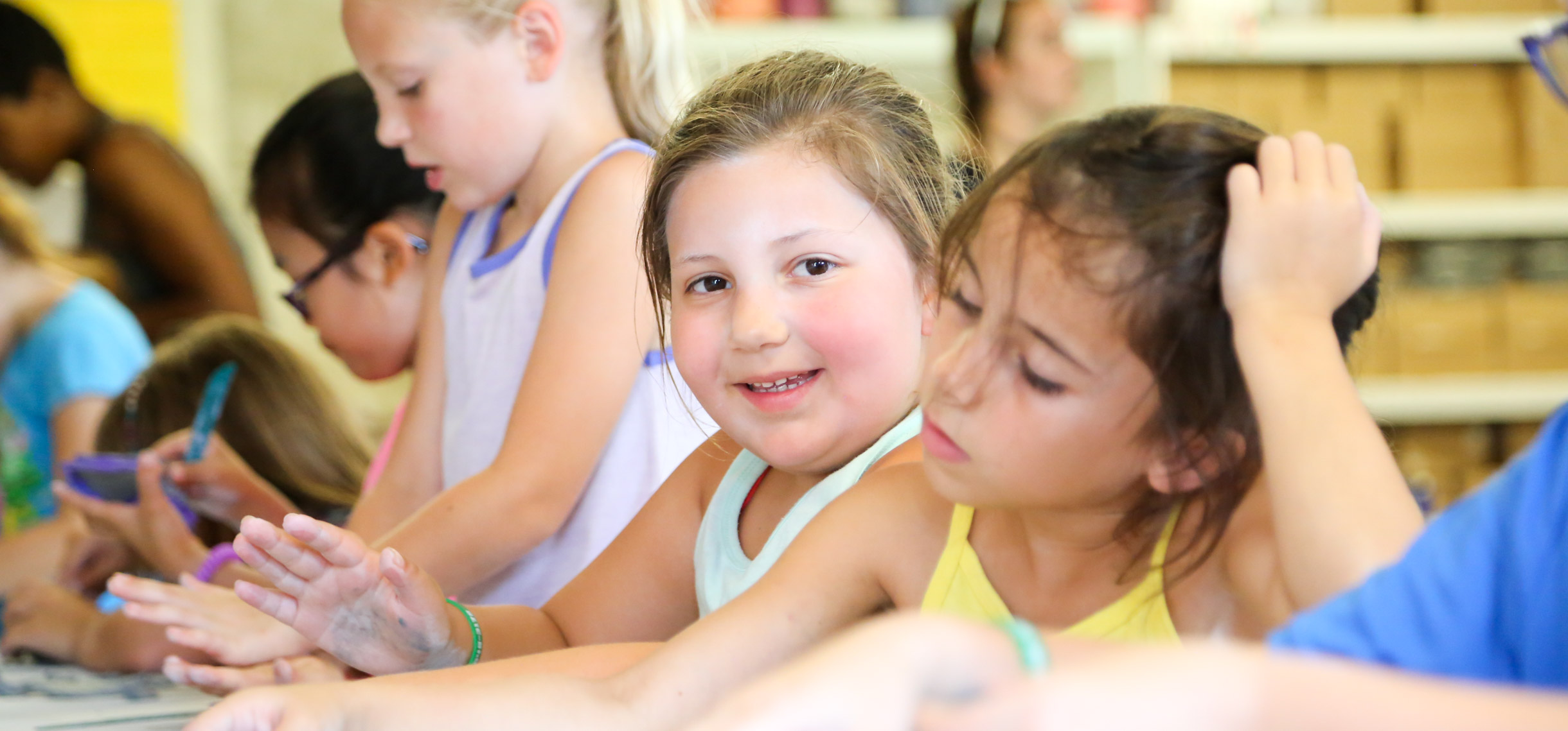 Campers at a table doing a school activity