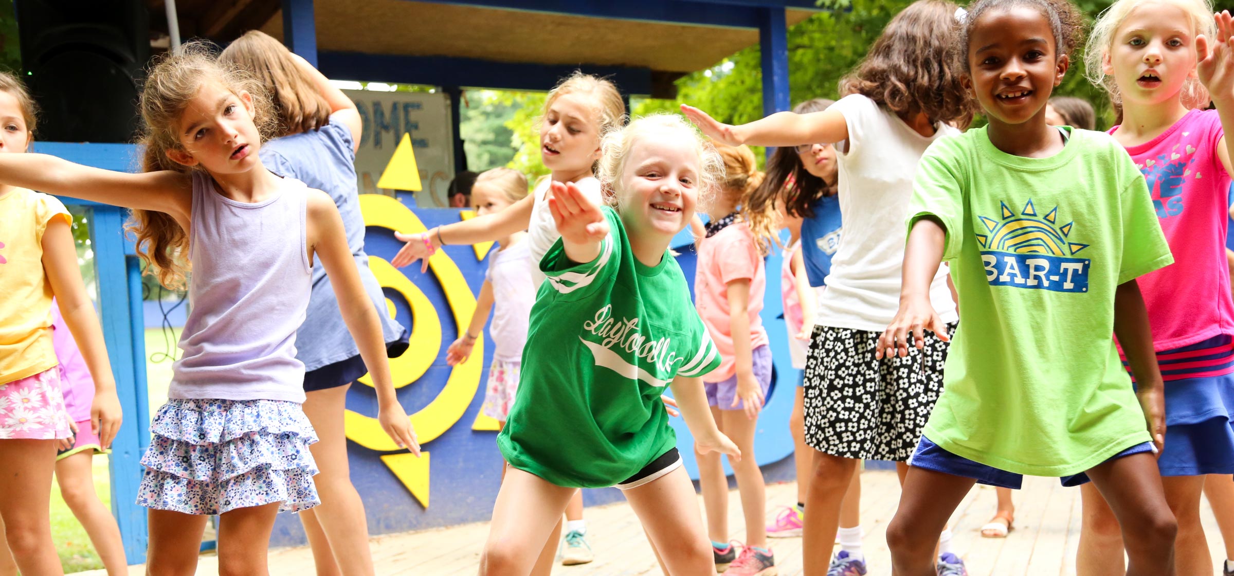 Group of campers dancing on a stage