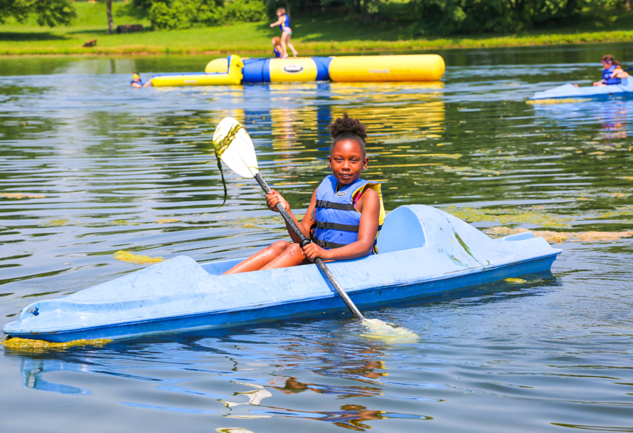 Camper kayaking on the lake