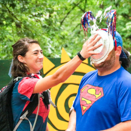 One counselor smashing a pie in another counselors face