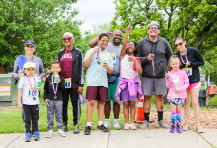 Group photo of campers and adults with 5k race medals