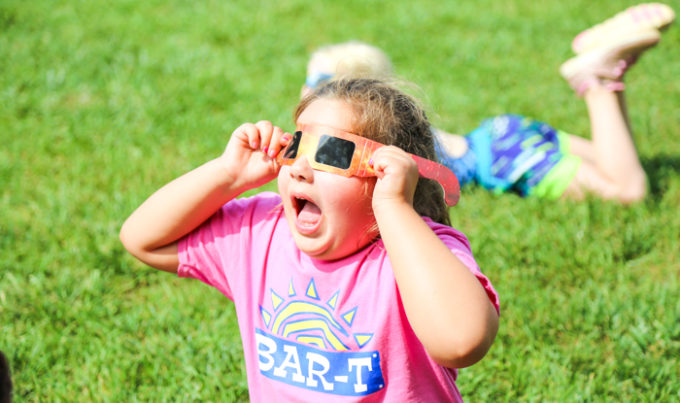 Camper with 3-D glasses on with mouth wide open in amazement