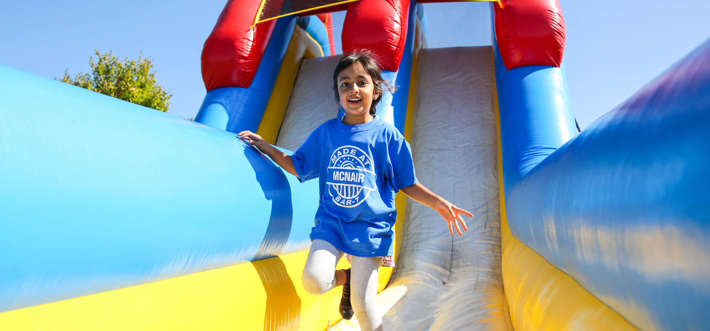 Camper running down a blow up slide castle