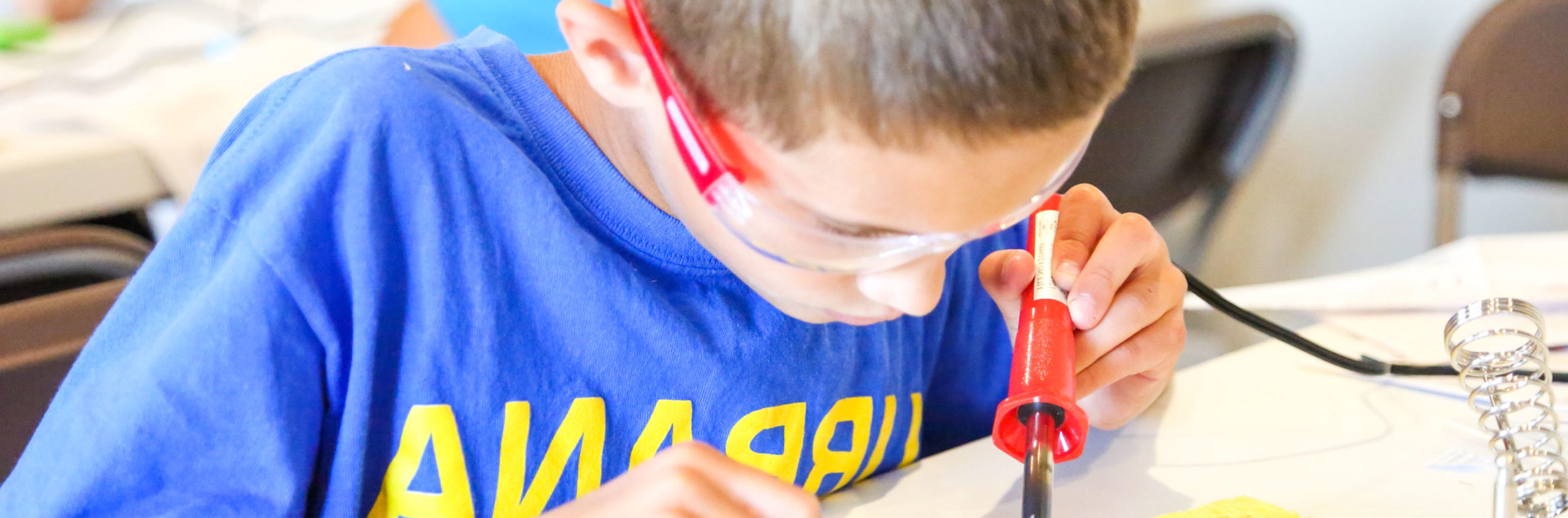 Camper concentrating on soldering something