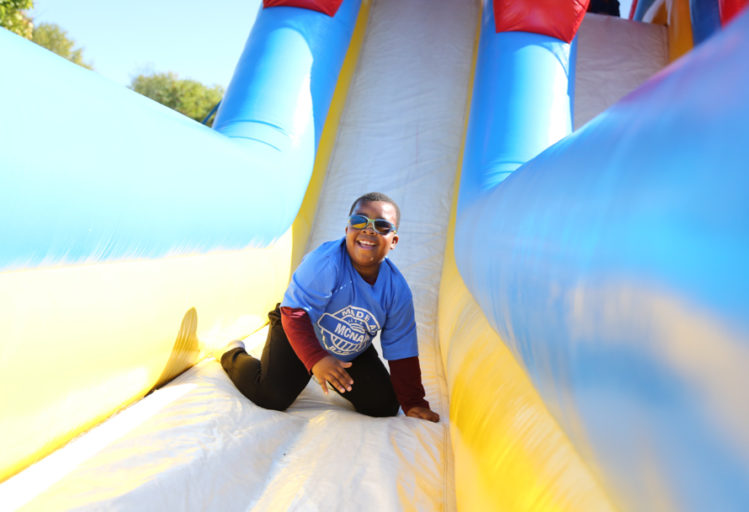 Camper sliding down a large inflatable slide