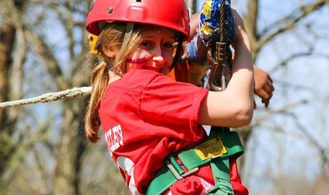 Girl camper on a zip line