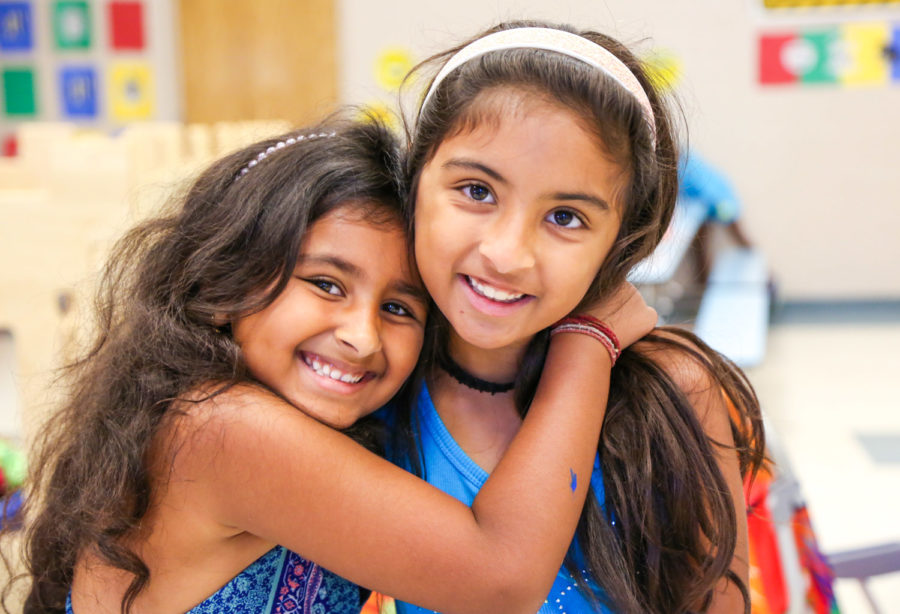 Two girls hugging and smiling for a photo