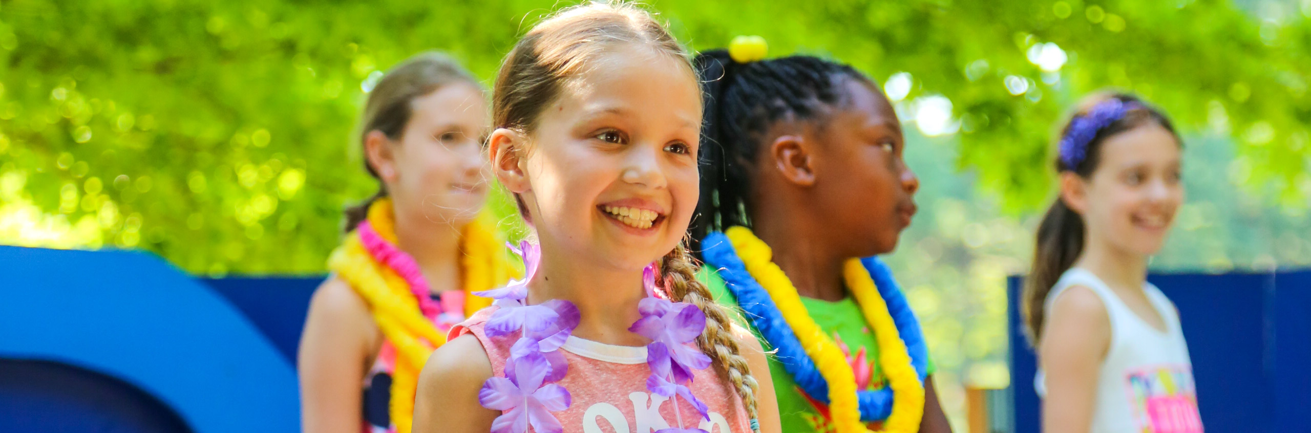 Campers performing and smiling on stage