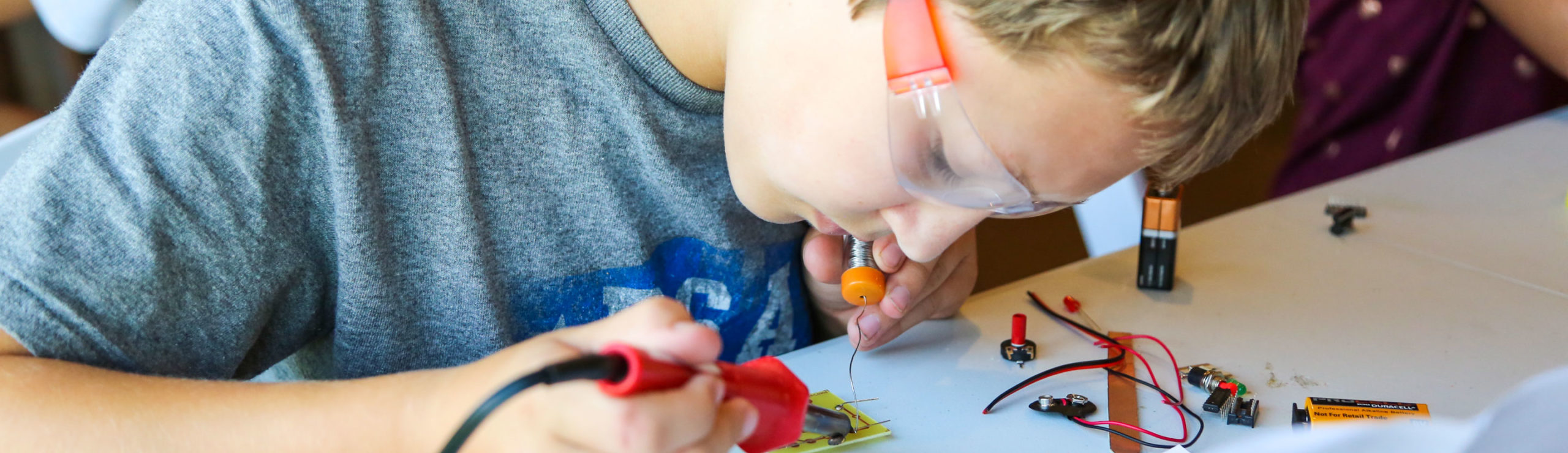 boy soldering something together